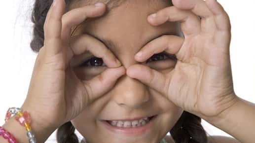 smiling girl with hand glasses