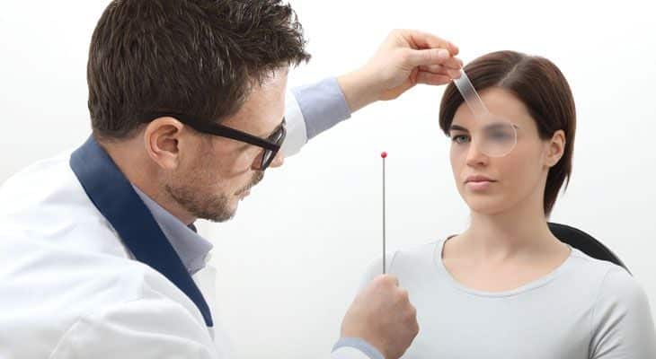 Optometrist examining patients eyes