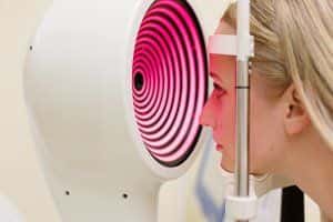 woman undergoing cornea curvature testing 