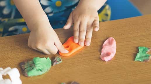 child playing with putty